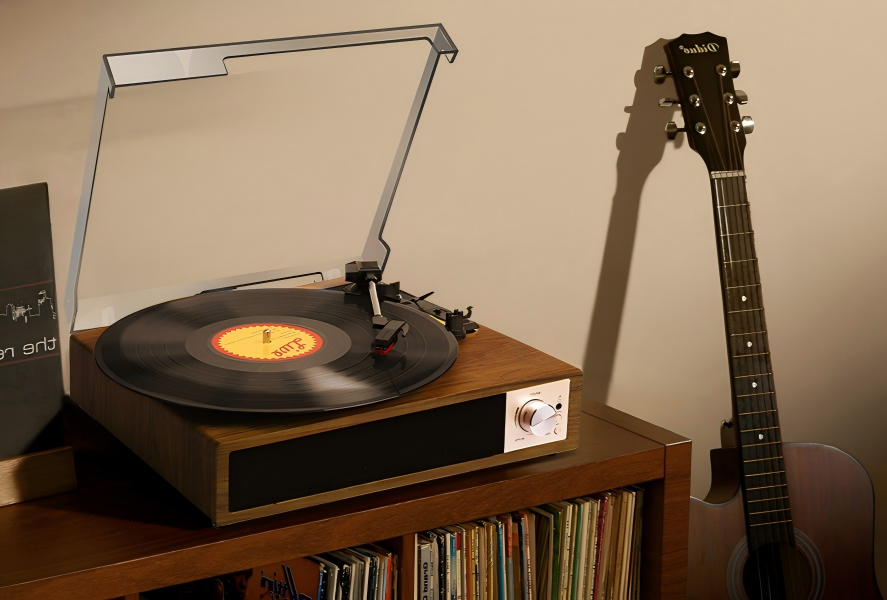 Vintage wooden record player with brass details and manual operation